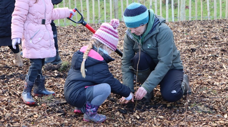 Young pupils get stuck in to tree planting