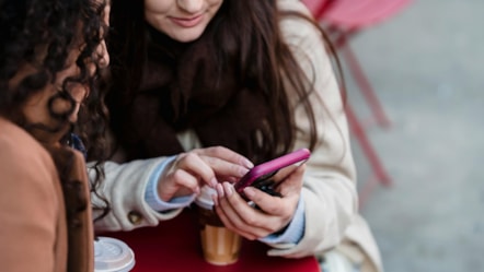 Drinking coffee while scrolling phone