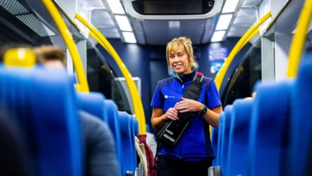 Image shows female conductor on-board Northern train