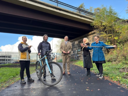 Cllr Warren Goldsworthy cuts the ribbon to officially open the new pathway with representatives from Preston City Council, Avanti, Network Rail and Community Rail Lancashire