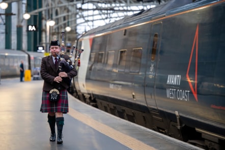 A bagpiper sends off the poppy wreath at Glasgow Central station