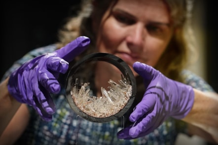 Dr Rachel Walcott, Principal Curator of Earth Systems, with a plastic pipe containing gypsum crystals, image copyright Stewart Attwood
