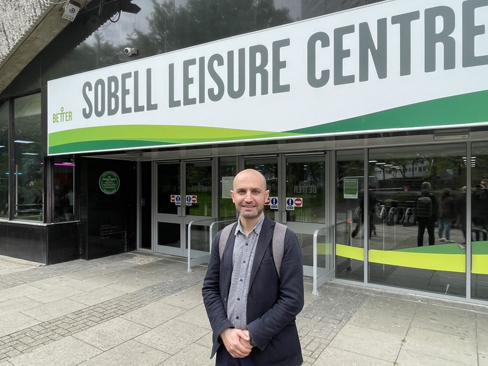 Cllr Nurullah Turan stands outside the entrance to the Sobell Leisure Centre