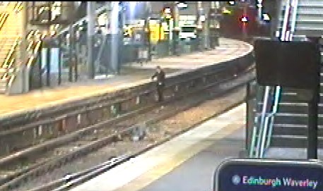 Edinburgh Waverley Trespass 2: The first man darts across the track before clambering up the other side