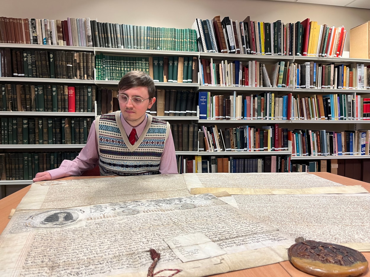 The Leeds Charter: Alex Pearson, archives assistant with West Yorkshire Archive Service with the copy of the Leeds Charter and  a second ornate charter, granted decades later in 1661 by Charles II.
The granting of the prestigious charter changed the course of the city’s history, laying the foundations of modern-day Leeds by incorporating it as a “free borough” and a “body corporate and politic.”