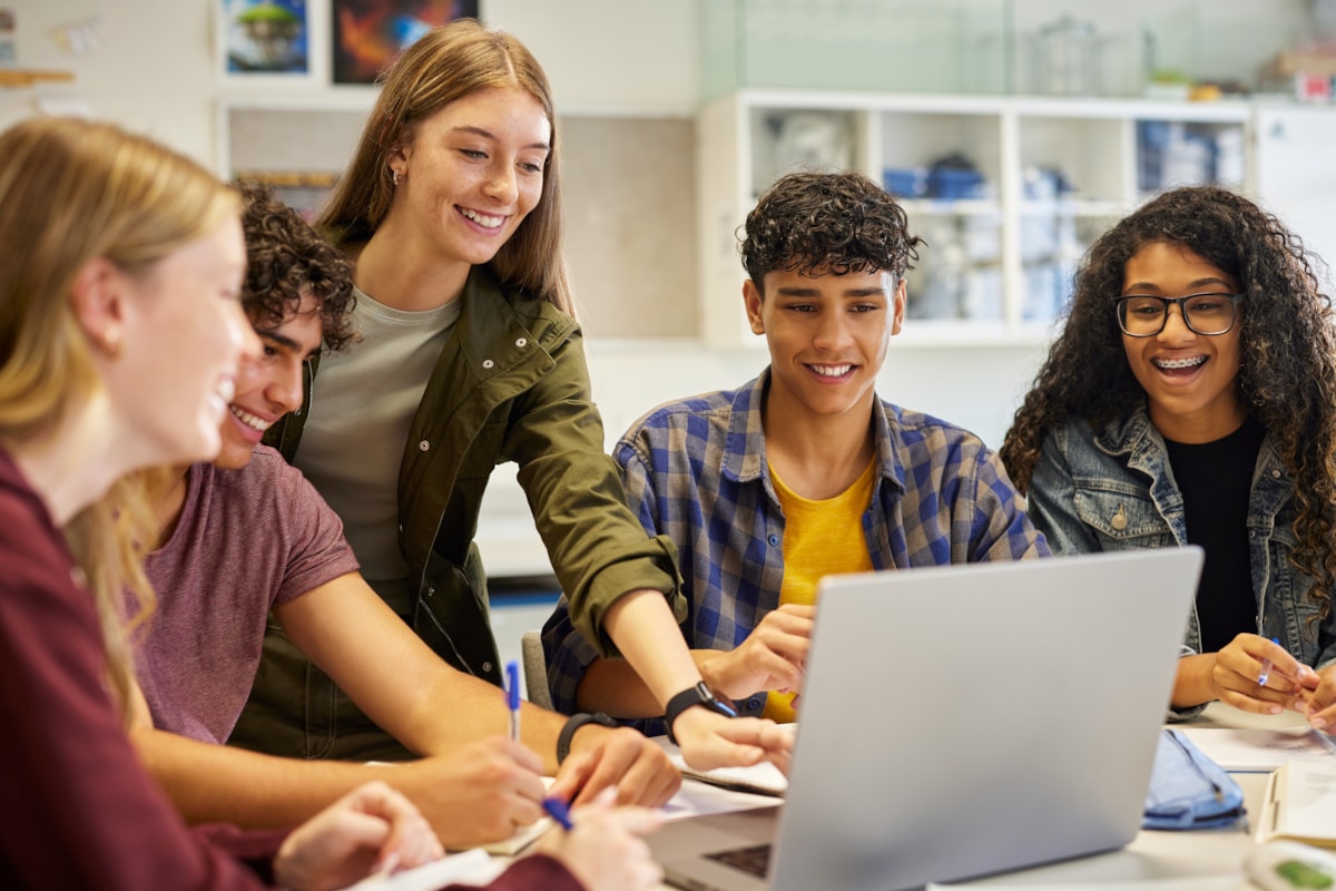 A group of students working on laptops.