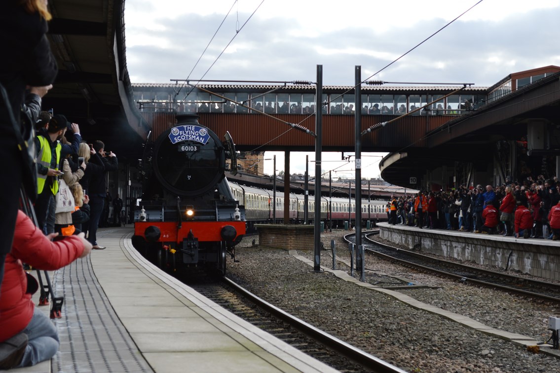 The Flying Scotsman pulls into York with platforms crowded and the over bridge full