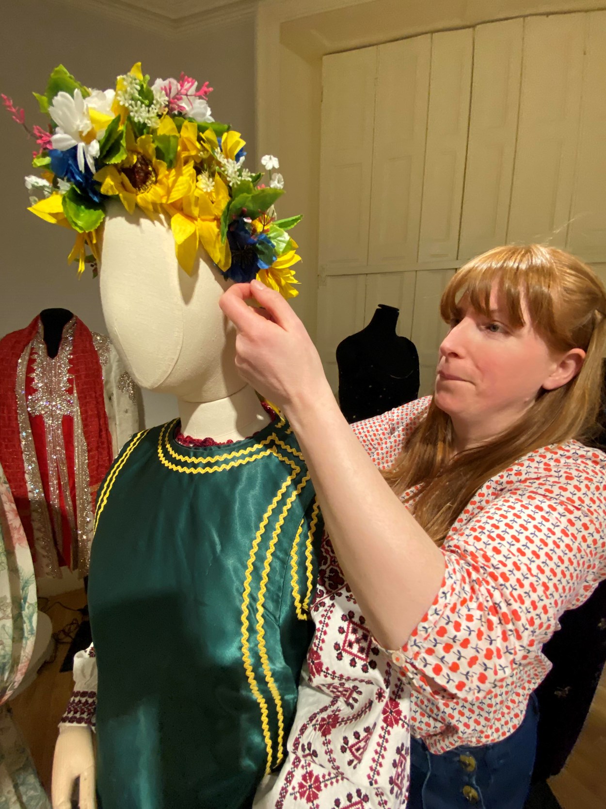 Ukrainian dress loan: Curator Natalie Raw works on the Ukrainian dress in the fashion gallery at Lotherton. From the central region of Ukraine, the costume consists of an embroidered shirt called a Vyshyvanka, which is worn along with a Vynok headdress and a sleeveless jacket called a Korstka.