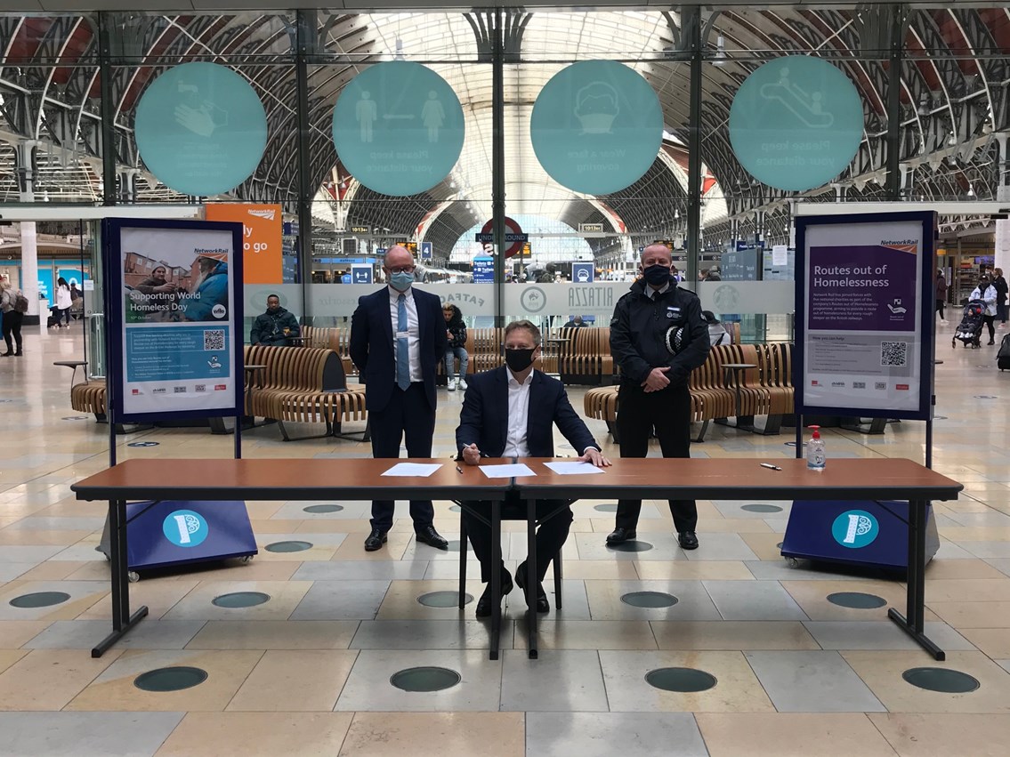 Rail industry and charities join forces to tackle street homelessness with new Rough Sleeping on Rail Charter: Andrew Haines, Grant Shapps and Charlie Doyle signing homelessness charter