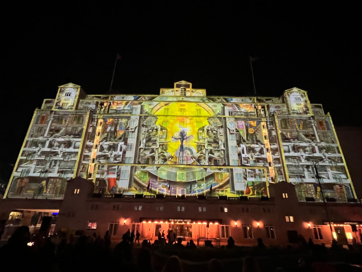 Light Night 2024: At The Queens Hotel The BookBinder saw a fairy tale figure lead a cast of birds, beasts and boats, in an impressive projection across the iconic hotel’s façade.
A collaboration with the British Library and created by artists Illuminos,  the piece is inspired by British Library’s Flickr Commons collection which includes fantastical drawings, prints and images.