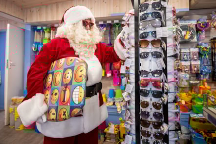 Santa sports some new sunglasses and surfboard at Devon Cliffs