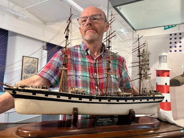 Model ships: Curator John McGoldrick with a replica of “cursed” wool clipper Cromdale, built in Glasgow in 1891.
After narrowly escaping disaster when her maiden voyage was hit by freak 300ft high icebergs, she later ran aground in thick fog, ploughing into cliffs off the coast of Cornwall, where her wreck is still visible today.