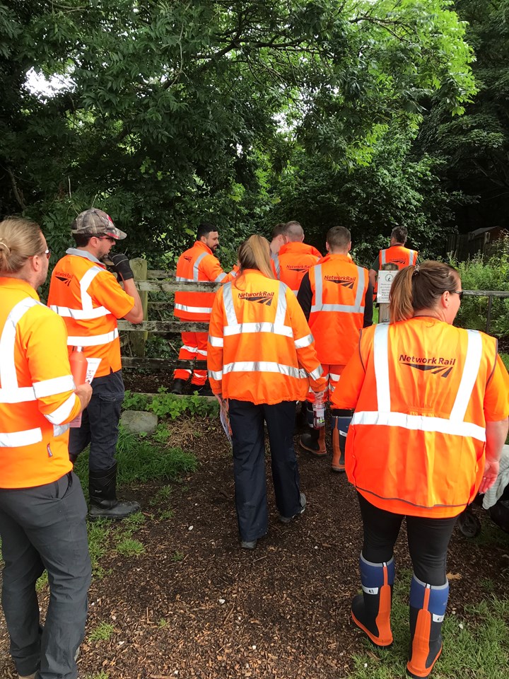 Network Rail volunteers walking to site for Balsam bashing in Stockport