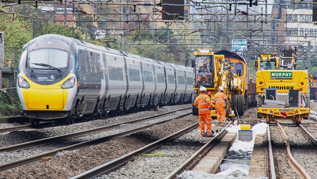 Rapid railway renewals on West Coast main line in North London: Avanti West Coast train passing Willesden track upgrade worksite March 2021