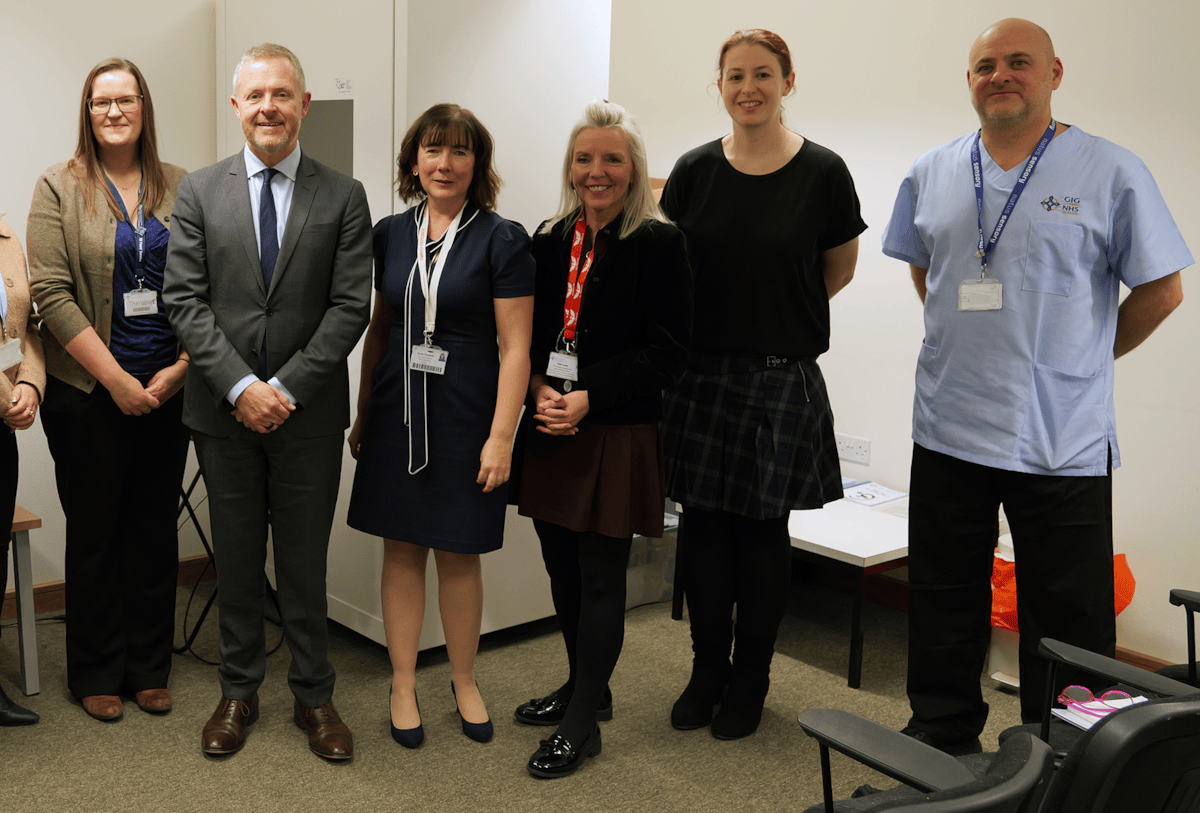 Cabinet Secretary for Health and Social Care with an audiologist and other staff at Clydach Primary Care Centre, Swansea