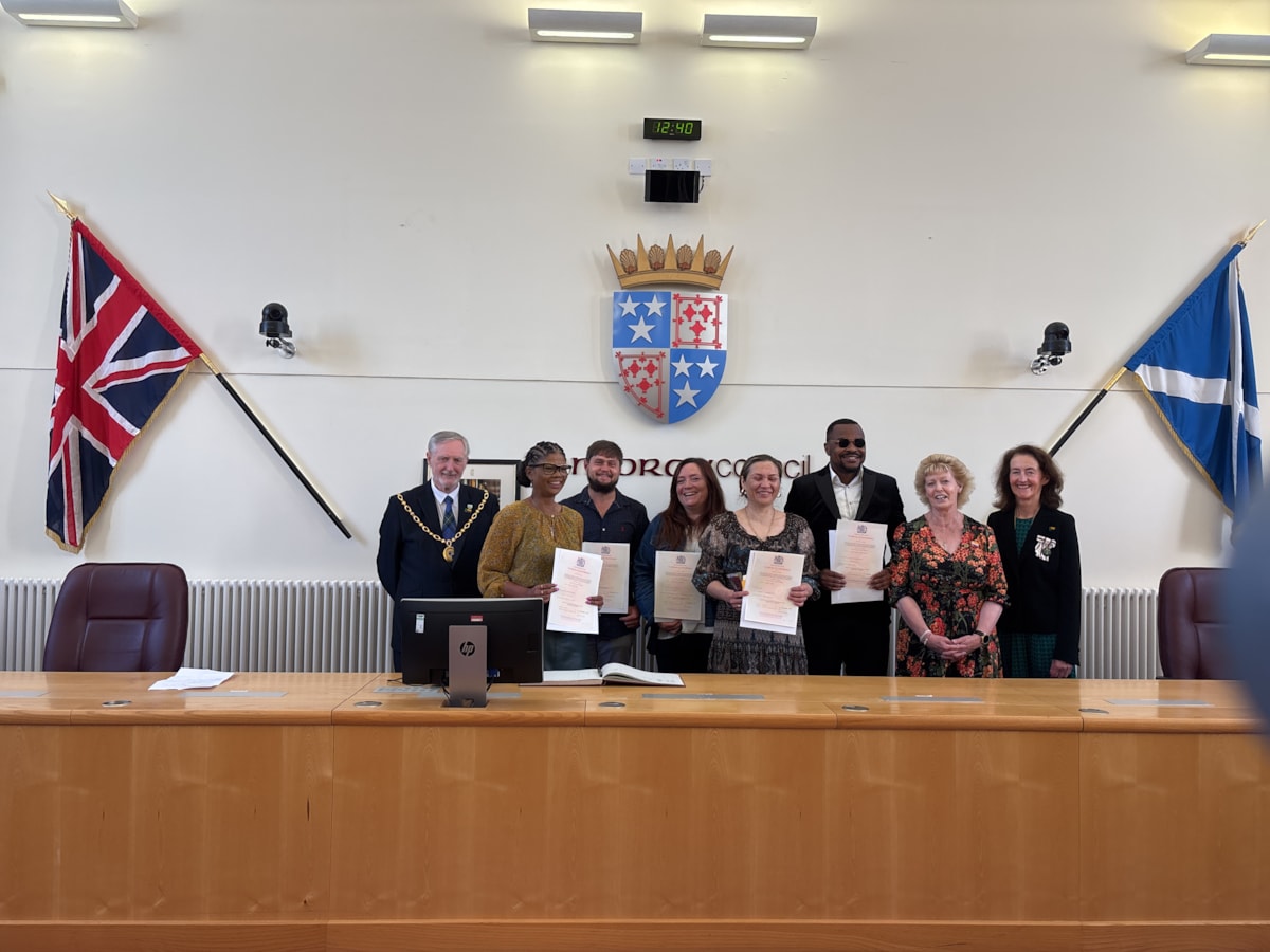 A group photo of the first citizenship ceremony to take place in the Moray Council chambers due to the registration services moving to HQ.

L-R: Moray Council Civic Leader, Cllr John Cowe; Salma Ralph; Dehan Otto; Stacie Whitney; Yana Rabago; Chukwu Anolue; Deputy Lieutenant of Banffshire, Kay Gauld