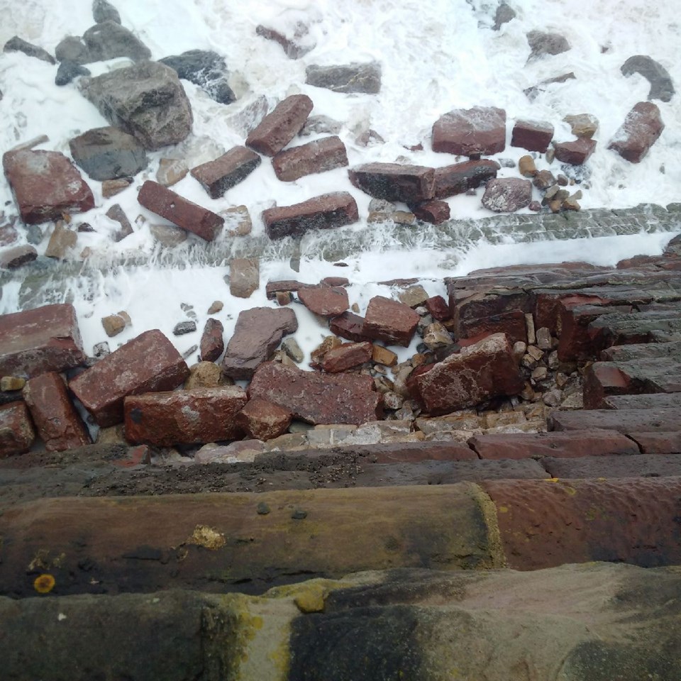Network Rail assessing track and sea wall damage on the Cumbrian coast line: Sea wall breach at Parton