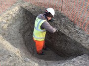 Archaeologist investigating Linmere pit © Albion Archaeology: Archaeologist investigating Linmere pit © Albion Archaeology