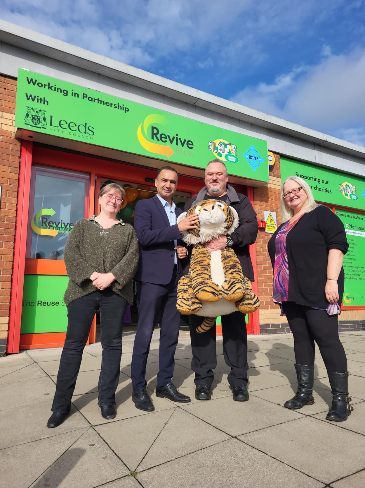 Reuse shop: Elizabeth Palmer CEO SLATE), Cllr Mohammed Rafique, Andrew Zbos (Revive Operations Manager) and Ali Ward (SLATE board rep) with a Reuse shop bargain.