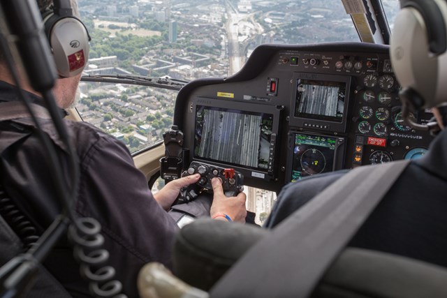 aerial- Surveying over Spa Road, London Bridge: Surveyor Sean looks for electrical faults on the thermal imaging camera, as he flies towards Bermondsey (top middle)