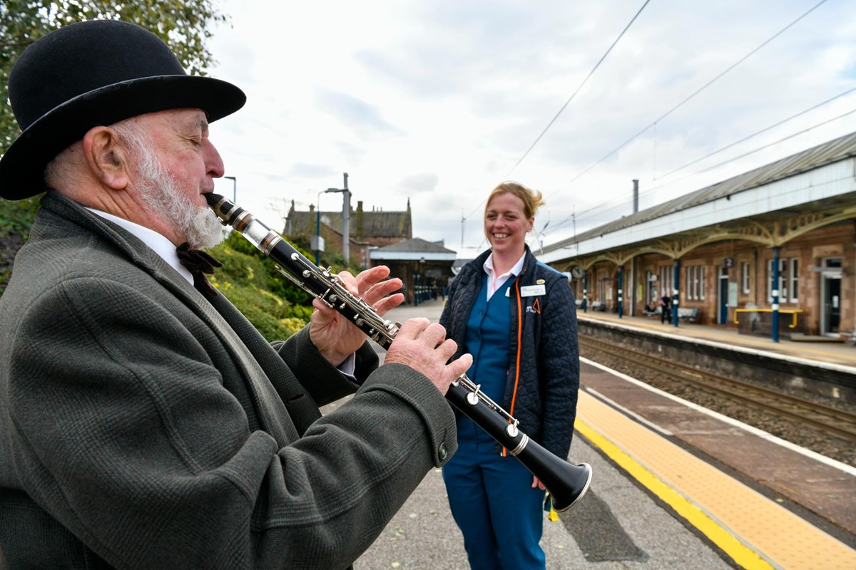 Philip Lowe performs a song for Avanti West Coast Team Leader, Jenny Fiddler, at Penrith station