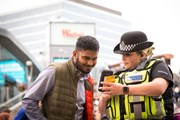 TfL Image - BTP Officer showing information to a member of the public