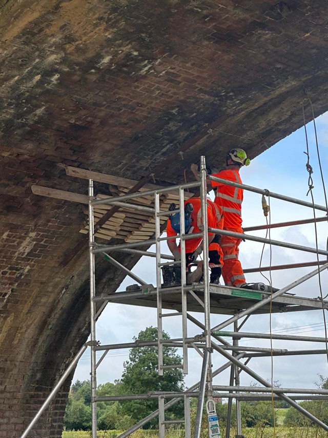 Network Rail engineers repointing one of the nine arches on River Avon viaduct: Network Rail engineers repointing one of the nine arches on River Avon viaduct