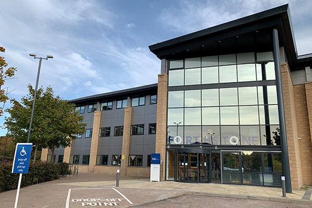 Motability Operations Edinburgh office - Forthstone: Image of office building taken from car park, blue skies visible in background