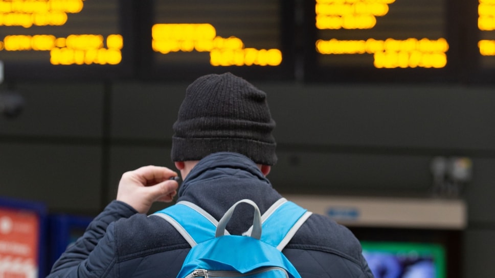 Image shows customer at departure screens