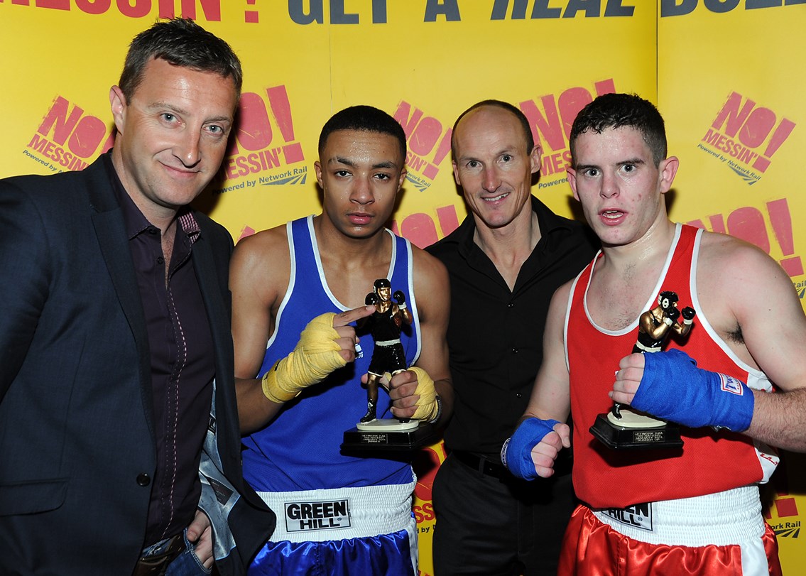Zelfa Barrett and Andrew Griffin receive trophies: Zelfa Barrett (in blue) from Moston and Collyhurst Boxing Club and Andrew Griffin (in red) from Bolton Elite receive trophies from Martin Gallagher (left) of Network Rail and David Lee (right) assistant academy director at Bolton Wanderers.