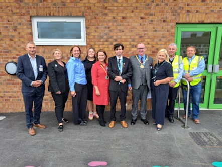 Pictured on the back row from left to right in front of the plaque at the official opening of the new facilities at Lea Community Primary School are representatives from Lancashire based construction company Warden Construction including Adrian Atkinson, director, Heather Thompson, social value coor