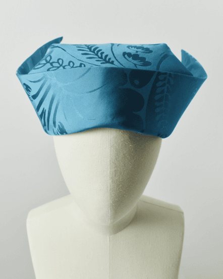 Image of a striking blue cornette on a mannequin.