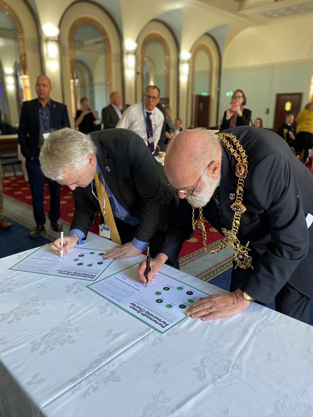 The Right Worshipful, the Lord Mayor of Portsmouth Councillor Canon Dr Hugh Mason (R) and Cllr Gerald Vernon-Jackson, Leader of Portsmouth City Council (L): The Right Worshipful, the Lord Mayor of Portsmouth Councillor Canon Dr Hugh Mason and Cllr Gerald Vernon-Jackson, Leader of Portsmouth City Council signing the Portsmouth Green Partnership Charter