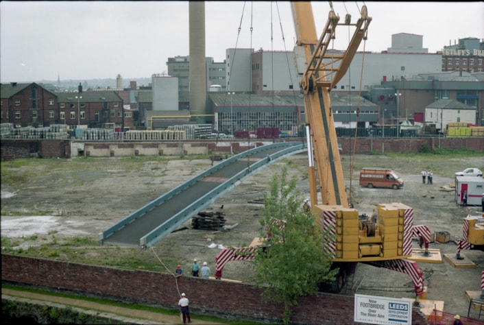 Centenary Bridge: Originally constructed in 1993, at that time the bridge was the first river crossing built in the city for more than a century, and its distinctive sweeping design has since become a much-loved riverside feature. Picture shows the bridge being winched into place during construction. Credit Yorkshire Design Group.