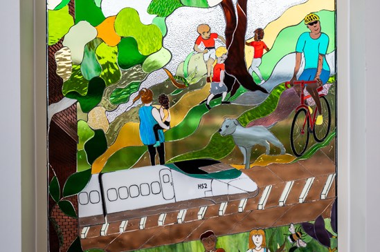 Stained glass window depicting the restored Burton Greenway, complete with an HS2 train.