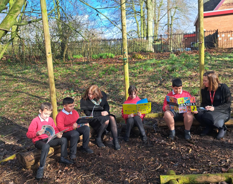 Pictured from left to right are pupils Manny and Ayush, headteacher Pam Maloney, pupils Abbie and Kaiyan and EAL team leader Roxana Sardais at the forest school at Howick Church of England Primary School 