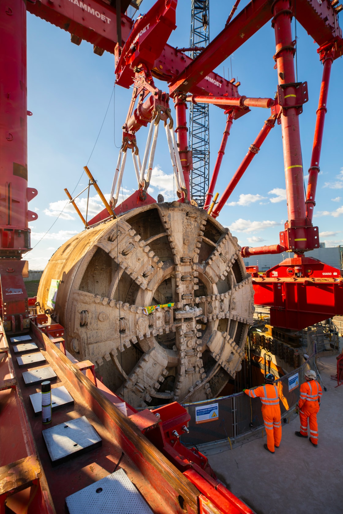 TBM Sushila removed after completing 5-mile journey to construct HS2's Northolt Tunnel under the capital-2: Following its 5-mile drive underneath the capital, HS2 lifted Tunnel Boring Machine (TBM) ‘Sushila’ out of the ground at the Green Park Way site in Greenford, West London.
 
The cutterhead, front and middle shield, weighting 880 tonnes, were lifted from the vent shaft in one piece on Saturday, March 15, using a 750 tonne gantry crane. The TBM – with a cutterhead spanning 9.48 metres in diameter – was launched from West Ruislip in October 2022 and completed its journey in December 2024. TBM Sushila excavated over 1.2 million tonnes of earth and installed 4,217 tunnel rings.
 
TBM Sushila was used to construct part of the Northolt Tunnel – an 8.4-mile tunnel being built by four TBMs which will take HS2 trains from Old Oak Common Station to the outskirts of the capital.

Copyright - HS2 Ltd