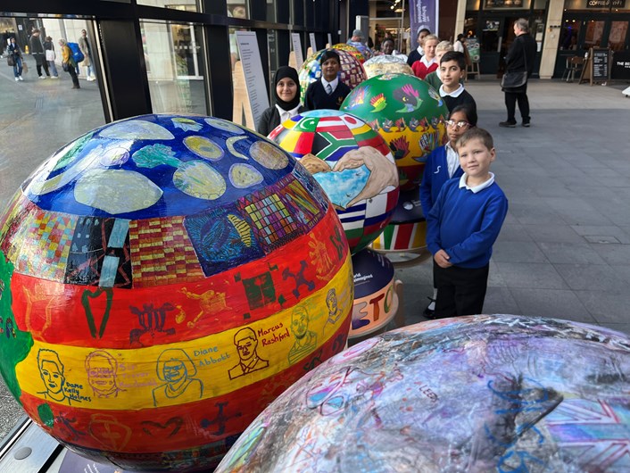 The World Reimagined: Children from Leeds schools who have made the globes now on display at Leeds train station as part of The World Reimagined cultural education project.