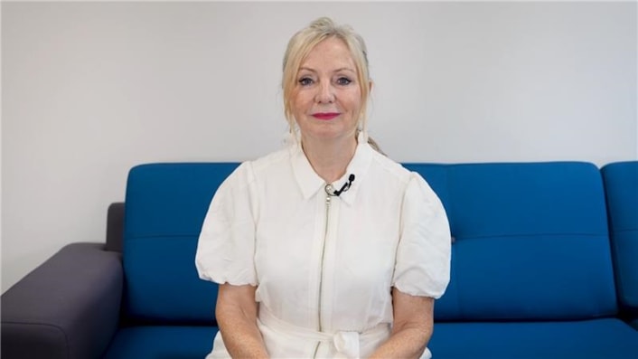 Suicide Prevention Champions - Tracy Brabin: Tracy Brabin is pictured sitting on a blue sofa, looking at the camera, in a still from the film.