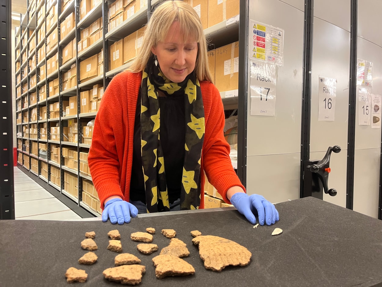 Pitty Close Farm finds: Kat Baxter, Leeds Museums and Galleries’ curator of archaeology, with some of the ancient Bronze Age finds made at Pitty Close Farm in Drighlington, Leeds.
As well as the cremated remains of a child and three adults, the dig uncovered fragments of a decorated clay urn, part of a pin which was carefully carved from a piece of animal bone and the shattered blade of a delicately honed flint knife.