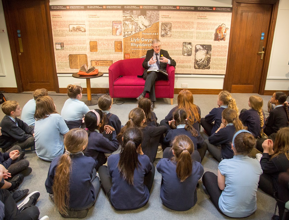 First Minister reads extracts of the Mabinogion to school pupils in the national Library of Wales ahead of World Book Day