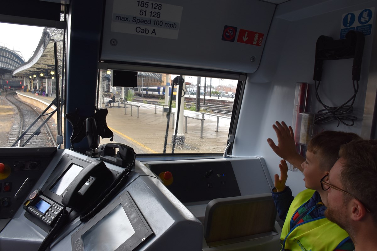 Ernie and Paul Skelton waving to passengers as they pull into York