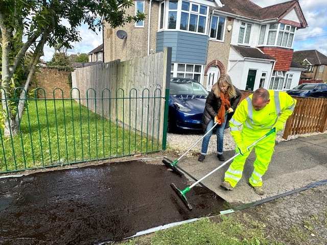 Councillor Karen Rowland and a member of the Council Highways team apply the pavement coating-2