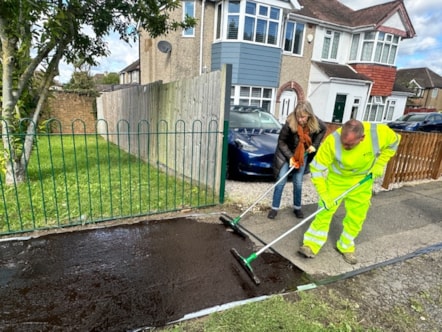 Councillor Karen Rowland and a member of the Council Highways team apply the pavement coating-2