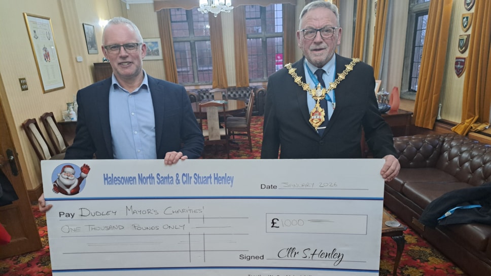 Cllr Stuart Henley presents the Mayor with a cheque for his charities