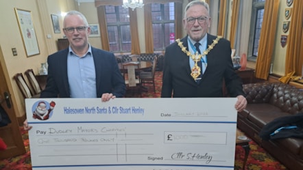 Cllr Stuart Henley presents the Mayor with a cheque for his charities
