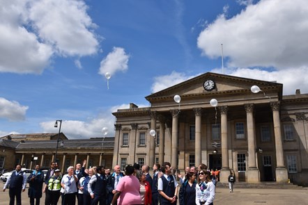 Memorial balloons released outside of Huddersfield Station in honour of Qazi Mahmood