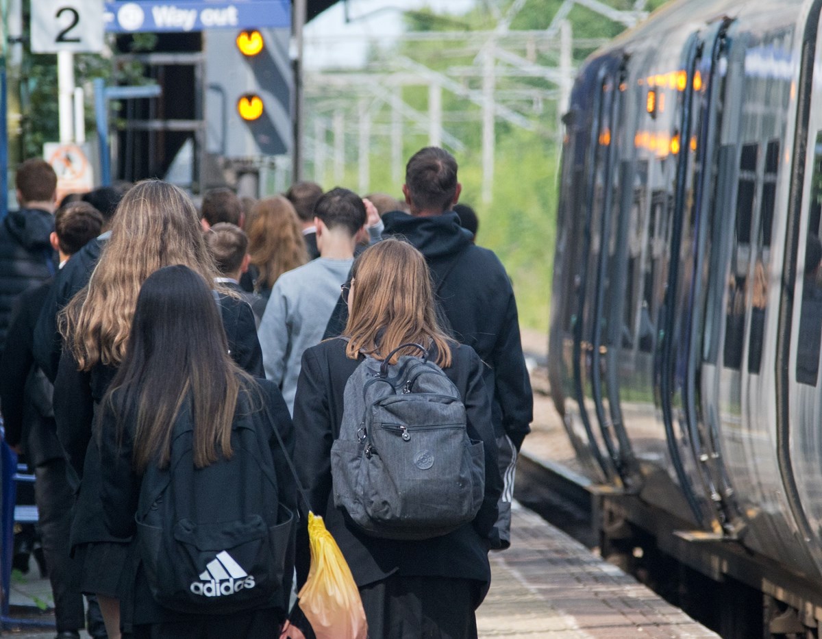 Image shows schoolchildren alongside a Northern train at a platform