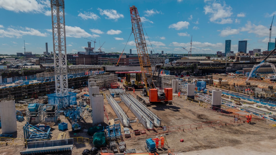 Crawler crane lifting a U-beam on the site of what will become a tram stop for the Midlands Metro June 2026