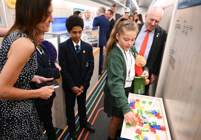 Amiee Lowe demonstrates an exhibit in the careers based Future carriage to Rail Minister Lord Peter Hendy (right) and Railway 200's Emma Roberts (left): Amiee Lowe demonstrates an exhibit in the careers based Future carriage to Rail Minister Lord Peter Hendy (right) and Railway 200's Emma Roberts (left)